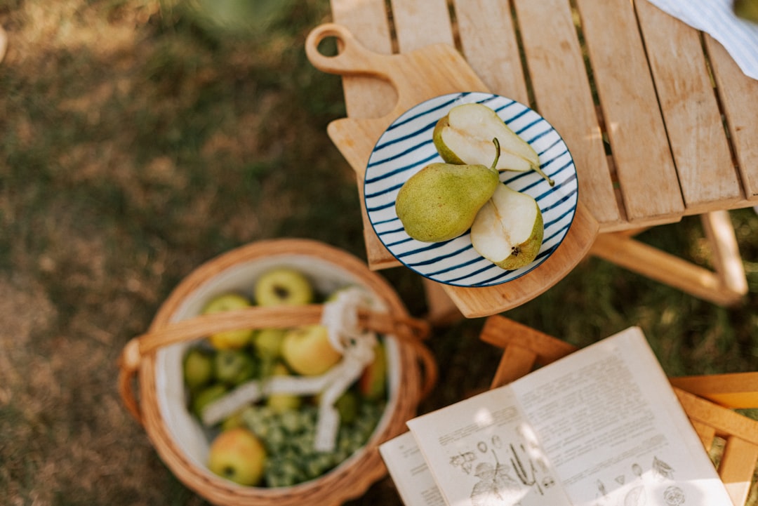 a-picnic-table-with-apples-and-vegetables-on-it-l4pl2kja6po