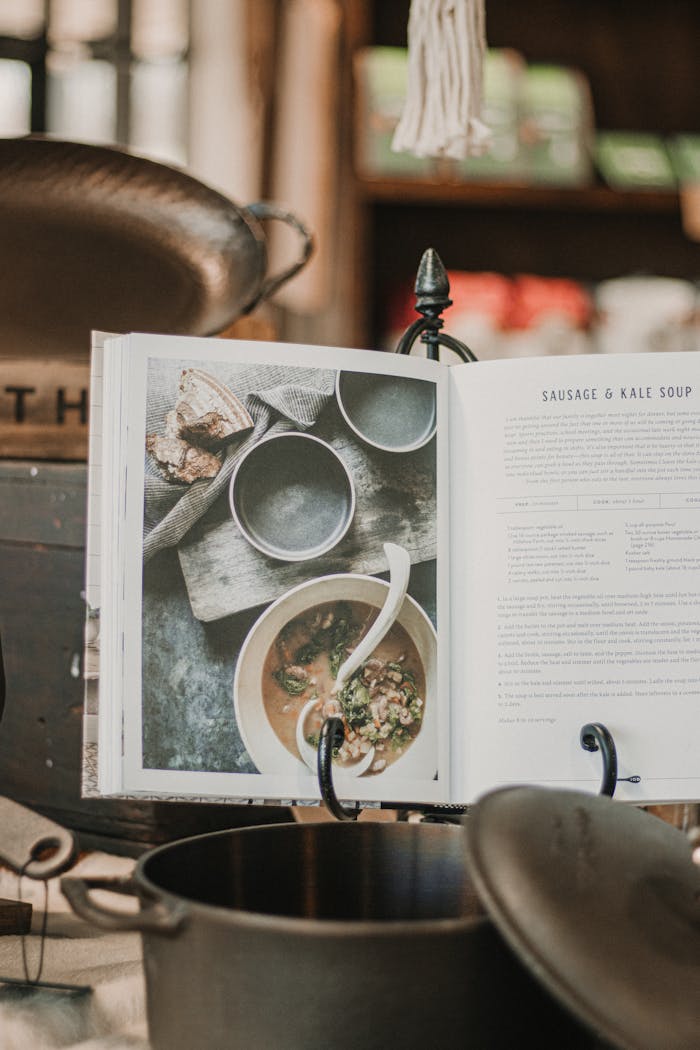 Open cookbook in rustic kitchen setting with cozy lighting.